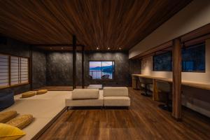 a living room with two chairs and a table at the Terrace 長浜 in Kure