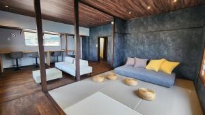 a living room with a couch and a table at the Terrace 長浜 in Kure