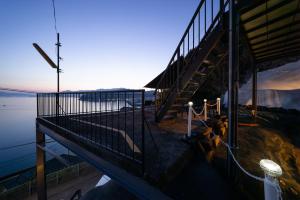 a building with a staircase next to the water at the Terrace 長浜 in Kure +33 photos