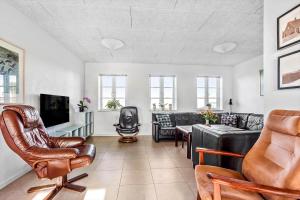 a living room with leather chairs and a couch at FY285-Faaborg-Egsgyden-35 in Fåborg