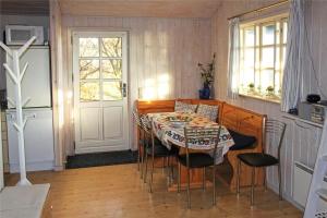 a dining room with a table and chairs and a door at FY320-Nyborg-Strandskovvej-9 in Nyborg