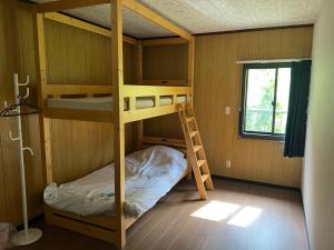 Ένα ή περισσότερα κρεβάτια σε δωμάτιο στο ゲストハウスまみむ +43 φωτογραφίες