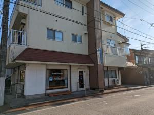 a building on the side of a street at Corpo Tenma Guesthouse Pegasus - Vacation STAY 55414v in Takayama