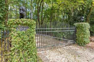 a metal gate with ivy on it in a park at Boview Hall- Poo l Hot Tub-15 mins to Kiawah in Johns Island