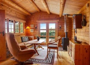 a living room with a table in a log cabin at LF21543-Spottrup-Tyttebaervej-10 in Lem