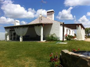 a white house with a flag on top of it at Courela do Salgueiro in Carocha