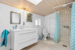 a bathroom with a white sink and a toilet at LF14198-Roslev-Bagvejen-2 in Roslev