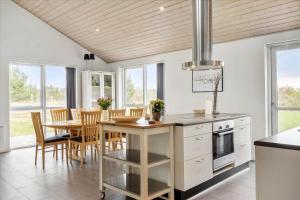 a kitchen and dining room with a table and chairs at LF15198-Hojslev-Bronzehojen-7 in Højslev +14 photos