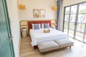 Postel nebo postele na pokoji v ubytování JOYY Villa 4PN-3WC-5 giường NovaWorld Phan Thiết + 22 fotografií