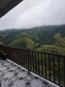 a balcony with a view of the mountains at Dad's Place Lodge and Restaurant in Banaue +5 photos