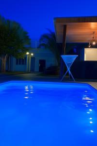 a swimming pool in front of a house at night at a Casa Paradisiaca lll Luxo Com Sinuca e Lavanderia com Roupa de Cama e Toalhas in Caldas Novas