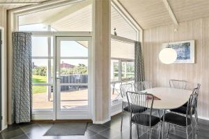 a dining room with a table and a sliding glass door at LF550-Vestervig-Ingersvej-20 in Vestervig