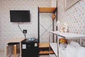 仁川市Reto House的房间里有一张桌子和一台挂在墙上的电视