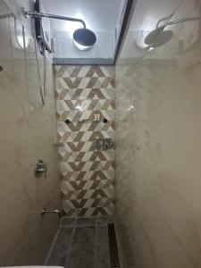 a bathroom with a shower with a tiled floor at MisyEdz Homes Dau Good for 2 near Clark, SNR,Malls, Airport in Mabalacat +36 photos