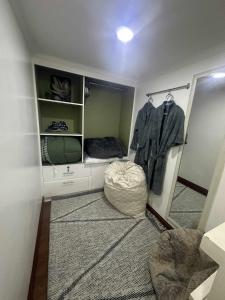 a room with a mirror and a ottoman in a room at MisyEdz Homes Dau Good for 2 near Clark, SNR,Malls, Airport in Mabalacat