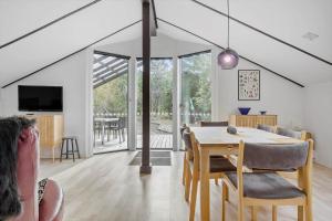 a dining room and living room with a table and chairs at LF581-Hurup-Thy-Haettemagevej-1 in Sindrup