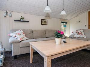 a living room with a couch and a coffee table at 6 person holiday home in Glesborg in Glesborg