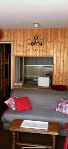 a room with a bed with a wooden wall at Studio la mongie de 33m2 à 150 m des pistes in La Mongie