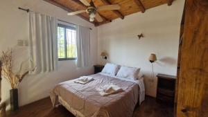 a bedroom with a bed with two towels on it at Altos del Campo in San José +38 photos