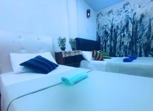 2 Betten in einem Zimmer mit blauem Licht in der Unterkunft Adams Green View Cottage in Ella