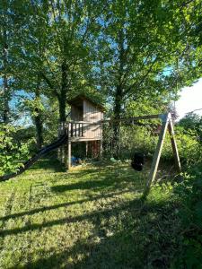 a playground in a yard with a swing at Modern Holiday Home By Holbæk Fjord in Holbæk