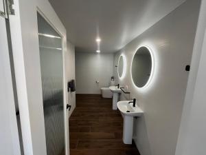 a bathroom with two sinks and two mirrors at Hotel Theodore  +31 photos