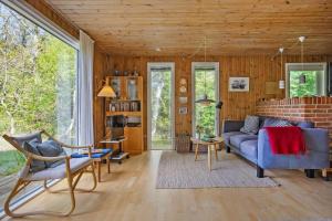 a living room with a blue couch and chairs at LF14138-Spottrup-Heden-11 in Spottrup