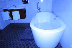 a bathroom with a white toilet and a sink at EE Maison Bed and Breakfast in Francistown +9 photos