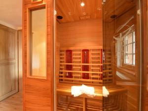 a sauna with wooden walls and a glass door at Holiday Home in Bullange with Sauna in Bullange +32 photos