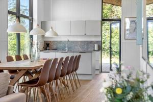a kitchen and dining room with a table and chairs at LF12002-Spottrup-Molleparken-17 in Spottrup