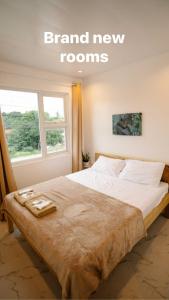 a large bed in a room with a window at MGM Tourist Inn in Tagbilaran City