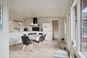 a kitchen with a table and chairs in a room at LF11129-Struer-Tvaervej-29 in Struer