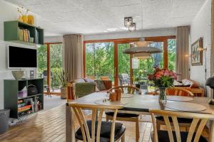 a living room with a table and chairs at LF10004-Thyholm-Agertoften-4 in Thyholm
