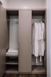 a walk in closet with white clothes at Catba SunWoo Homestay & Hotel in Cat Ba