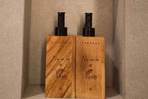 a couple of wooden bottles sitting on a shelf at Leafy Riverbank in Tabanan