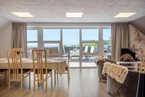 a dining room with a table and chairs with a view at LF10301-Hurup-Thy-Sindrupvej-1-B in Sindrup