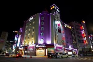 a purple building with cars parked in front of it at S Hotel in Gwangju