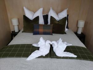 a bedroom with a bed with towels on it at Harbour Hideaway in Dunedin