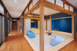 a living room with blue walls and wooden floors at 甚兵衛邸 in Hirado