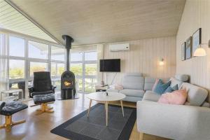 a living room with a couch and a fire place at LF453-Vestervig-Hannesvej-23 in Vestervig