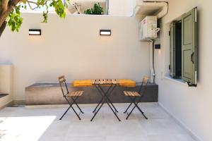 two chairs and a table on a patio at Lemon Tree Studio 1 in Mytilene