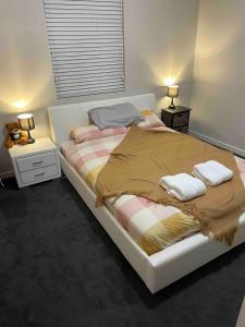 a bedroom with a large bed with two night stands at 1915 cottage renovated and ready in Boulder