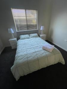 a bedroom with a large bed and a window at 1915 cottage renovated and ready in Boulder