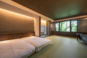 a bedroom with a large bed and a window at Ryokan Kono-Yu in Minamioguni +54 photos