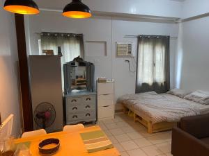 a small bedroom with a bed and a mirror at The Pahina Suite in Marilao +21 photos