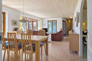 a dining room and living room with a table and chairs at LF11597-Struer-Plantagevej-97 in Struer