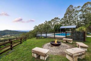 a backyard with a fire pit and a pool at The Farm on Razorback Ridge in Montville