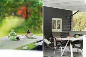 een tafel met een vaas erop en een tafel met stoelen bij LF10318-Hurup-Thy-Sortmejsevej-2 in Sønder Ydby
