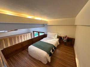 a bedroom with a large bed in a room at Leafy Riverbank in Tabanan +8 photos