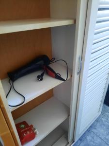 a black and red bag sitting on a shelf at DÉNY APARTMAN in Sfântu-Gheorghe